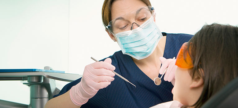 A female dentist treating a patient