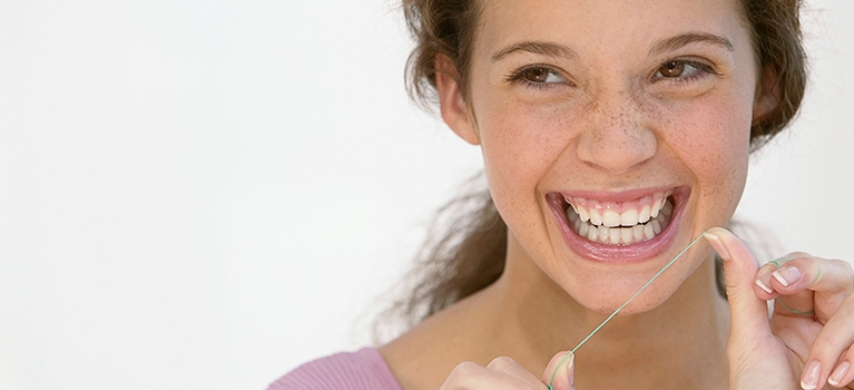 Young woman with dental floss