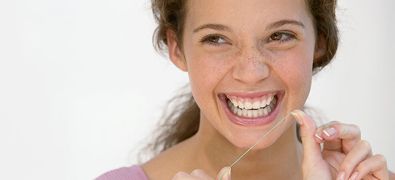 Young woman with dental floss