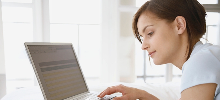 Young woman paying bills online